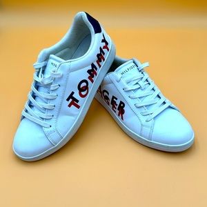 Tommy Hilfiger men’s size 12 white shoe with Logo on the side of each shoe.
